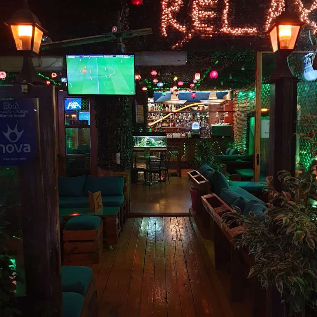 Cozy shisha lounge with TV screens and ambient lighting at Relax Cafe.