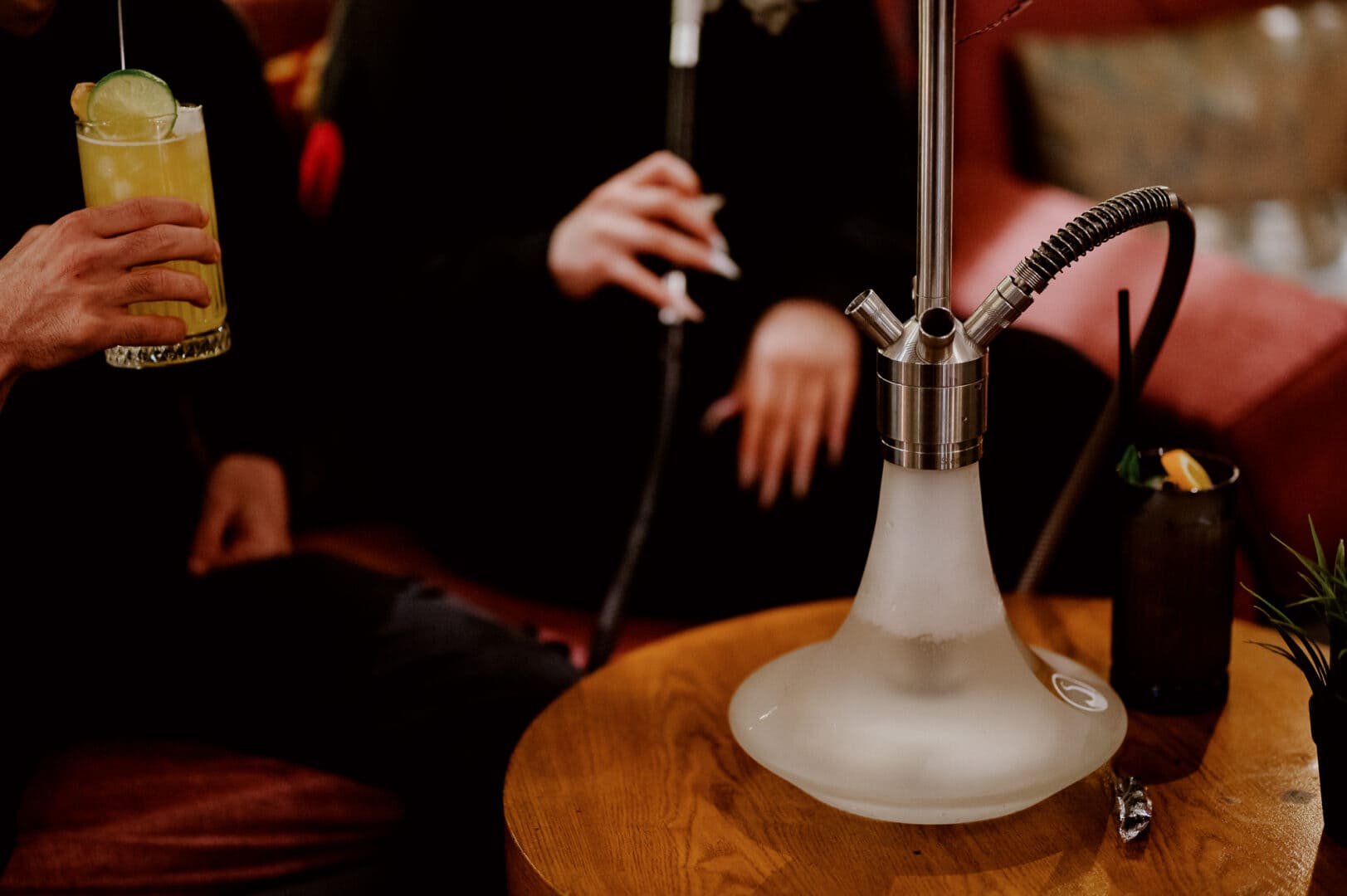 Modern hookah with smoke in a stylish lounge setting.