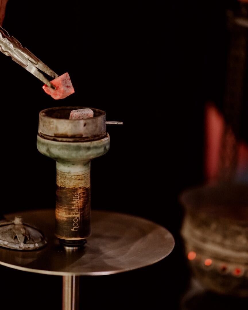 Hookah with charcoal and ice cubes at Shisha Break lounge.
